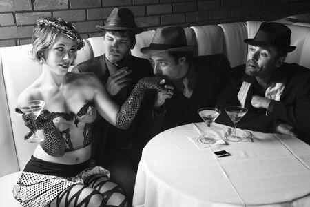 Three Caucasian prime adult males in retro suits wooing Caucasian prime adult female.の写真素材