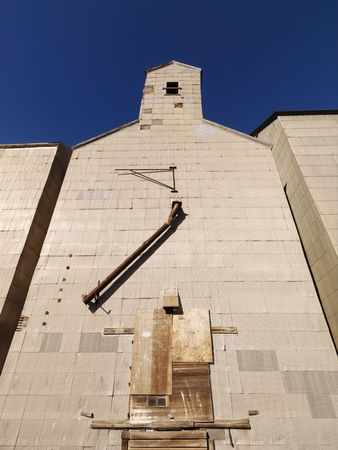 Low angle of abandoned metal grain elevator.の写真素材