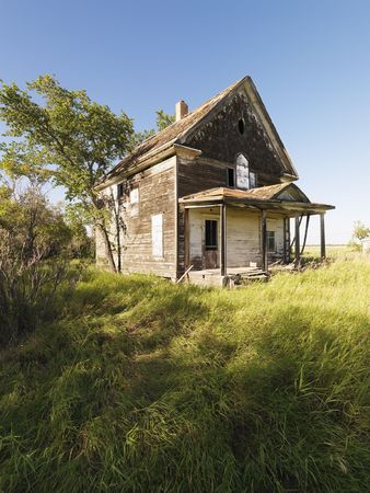 Abandoned farm house in rural field.の写真素材