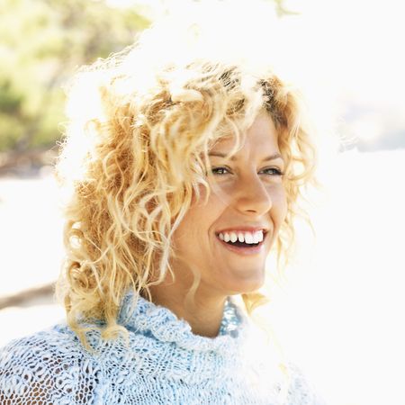 Close up portrait of attractive young blond woman smiling.の写真素材