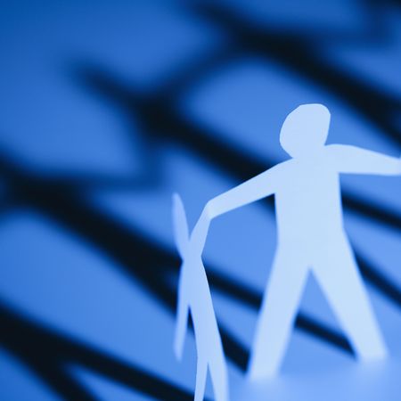 Paper cutout adult man and boy holding hands.の写真素材