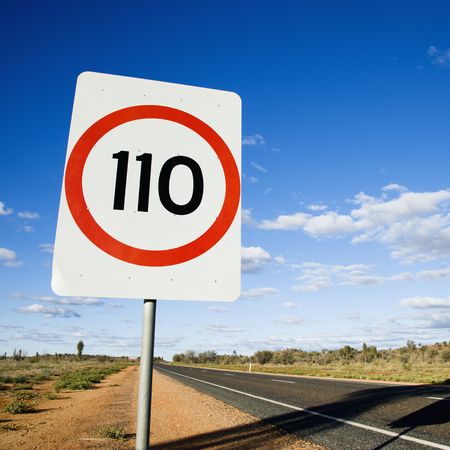 Speed limit kilometer per hour road sign by road in rural Australia.の写真素材