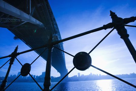 Low angle view at dusk from under Sydney Harbour Bridge in Australia with view of skyline and harbor.の写真素材