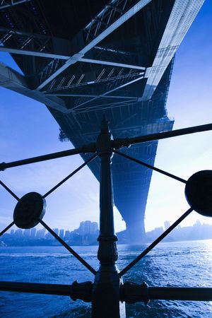 View from underneath Sydney Harbour Bridge in Australia at dusk with harbor and city skyline visible. の写真素材