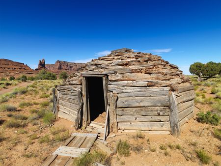 Desert landscape with rustic log cabin shelter.の写真素材