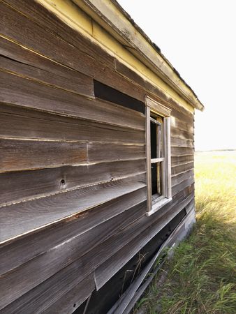 Side of abandoned wooden dilapidated house.の写真素材