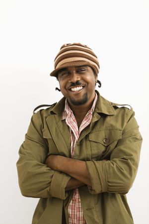 African-American mid-adult man wearing hat and smiling at viewer with arms crossed.の写真素材