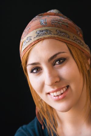 Young redheaded woman wearing cap smiling at viewer.の写真素材