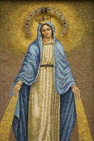 Mosaic of the Virgin Mary wearing a crown with device to give off light at night. Vertical shot.の写真素材