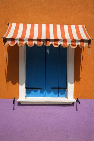 Colorful window with shutters and awning in Venice, Italy. Vertical shot.の写真素材