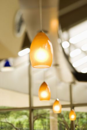 Selective focus view of a row of bright hanging lights. Vertical shot.の写真素材
