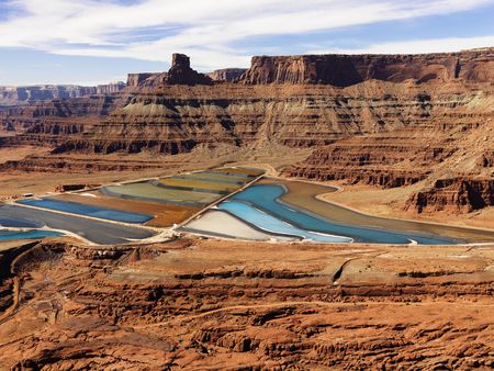 Aerial view of an arid, craggy landscape surrounding tailing ponds. Horizontal shot.の写真素材