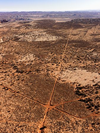 Aerial of intersecting dirt roads in a desert landscape. Vertical shot.の写真素材