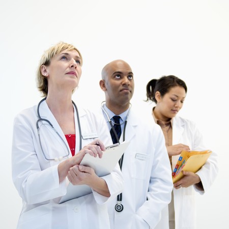 Portrait of three male and female doctors in lab coats.の写真素材