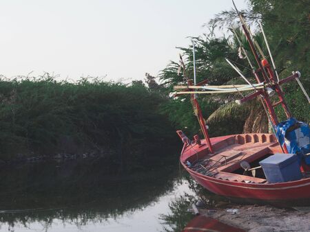 A fishing boat on the sand dunes is waiting for the sea to rise to catch fish again.の写真素材