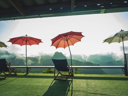 Restaurant and drink with just a chair and umbrella in the morning mist on a high peak.の写真素材