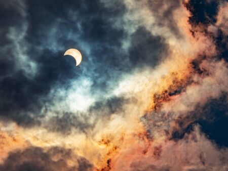 Solar eclipses caused by the shadow of the moon covering the sun In the midst of thick clouds, the end of the year 2019の写真素材