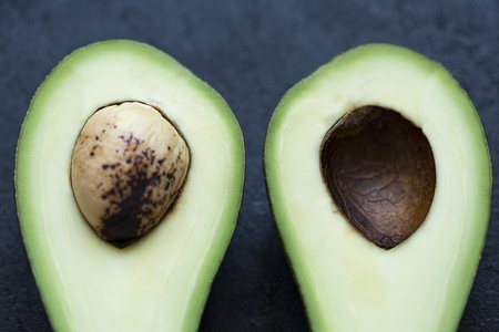 Avocado in a cut on a black backgroundの写真素材