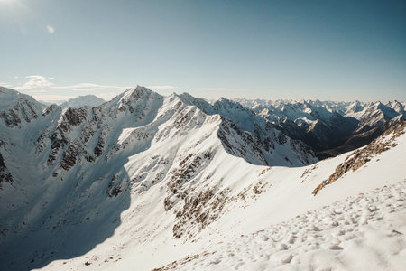 Mountain landscape with snow and clear blue sky. Caucasus Mountains, Georgia, Gudauri region.の素材