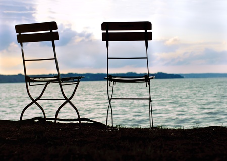 Two chairs near tha lake. silhouetteの写真素材