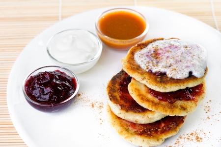 Fritters of cottage cheese with a jam and cour creamの写真素材