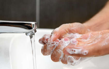 man is washing their hands