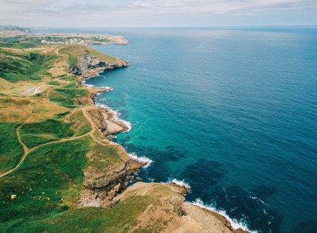 Scenic aerial view of coastal cliffs and turquoise sea stretching into the horizon.の写真素材