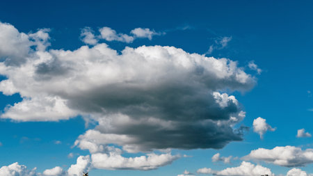 Large fluffy cumulus clouds in a bright blue sky.