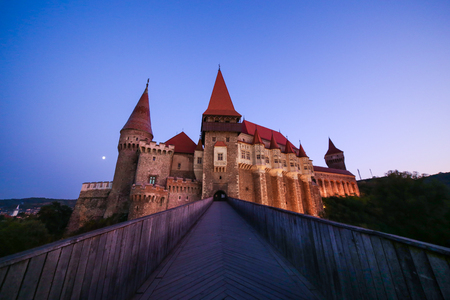 View from the wood bridge of Corvinilor Castle in the evening light in Hunedoara city, Hunedoara County, Romaniaのeditorial素材