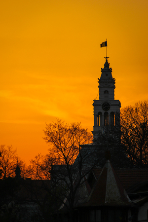 Bell tower of the Arad City Hall with sunset light background in Arad, Romaniaの写真素材