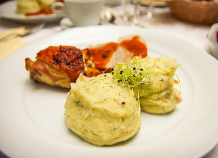Chicken breast steak with mixed mushed potatoes and spices on a white plateの写真素材
