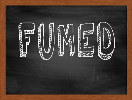 FUMED  hand writing text on black chalkboardの写真素材