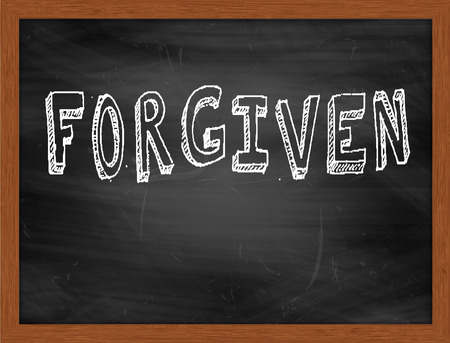 FORGIVEN  hand writing text on black chalkboardの写真素材