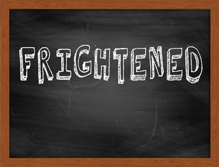 FRIGHTENED  hand writing text on black chalkboardの写真素材