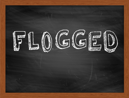 FLOGGED  hand writing text on black chalkboardの写真素材