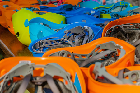 Detail of many safety helmets in different colors in a tree climbing adventure park