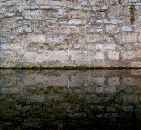 Brickwall and moat of an ancient castleの写真素材