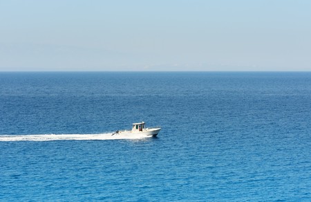 Motorboat cruising at the mediterranean seaの写真素材