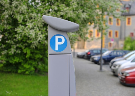 Pay and display machine with parking area in the backgroundの写真素材