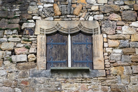 Part of an ancient wall of a medieval castle with windowの写真素材