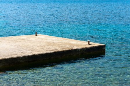 Small dock from concrete at a mediterranean beach
