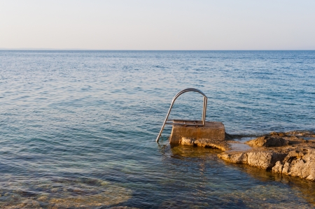 Stair for taking a bath in the rocky mediterranean sea in croatia の写真素材