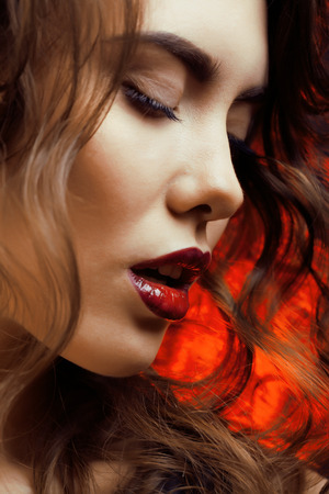 Beauty Woman with Perfect Makeup Beautiful Professional Holiday Make-up  Red Lips and Nails Beauty Girls Face isolated on Black background Glamorous Womanの写真素材