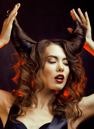 bright mysterious woman with horn hair, halloween celebrationの写真素材