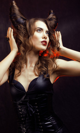 bright mysterious woman with horn hair, halloween celebrationの写真素材
