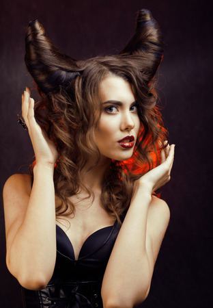bright mysterious woman with horn hair, halloween celebrationの写真素材