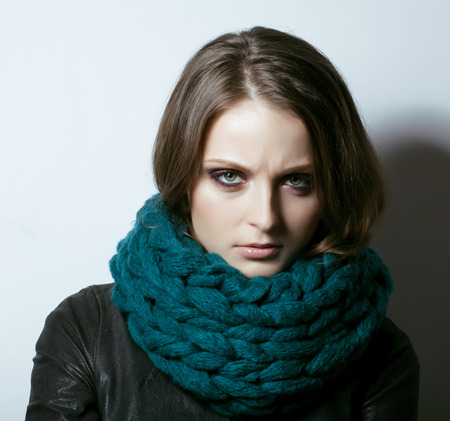 young pretty woman in sweater and scarf all over her face, winter coldの写真素材