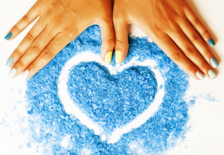 manicure with blue nails and seasalt close up like heart, love for summerの写真素材