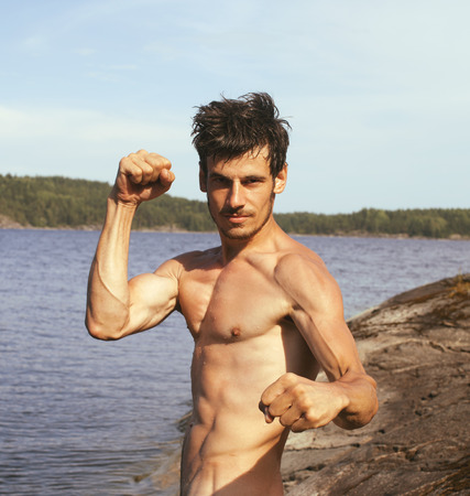 handsome young man at beach, hot vacations at lakeの写真素材