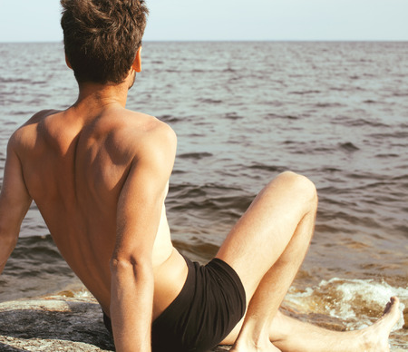 handsome young man at beach, hot vacations at lakeの写真素材